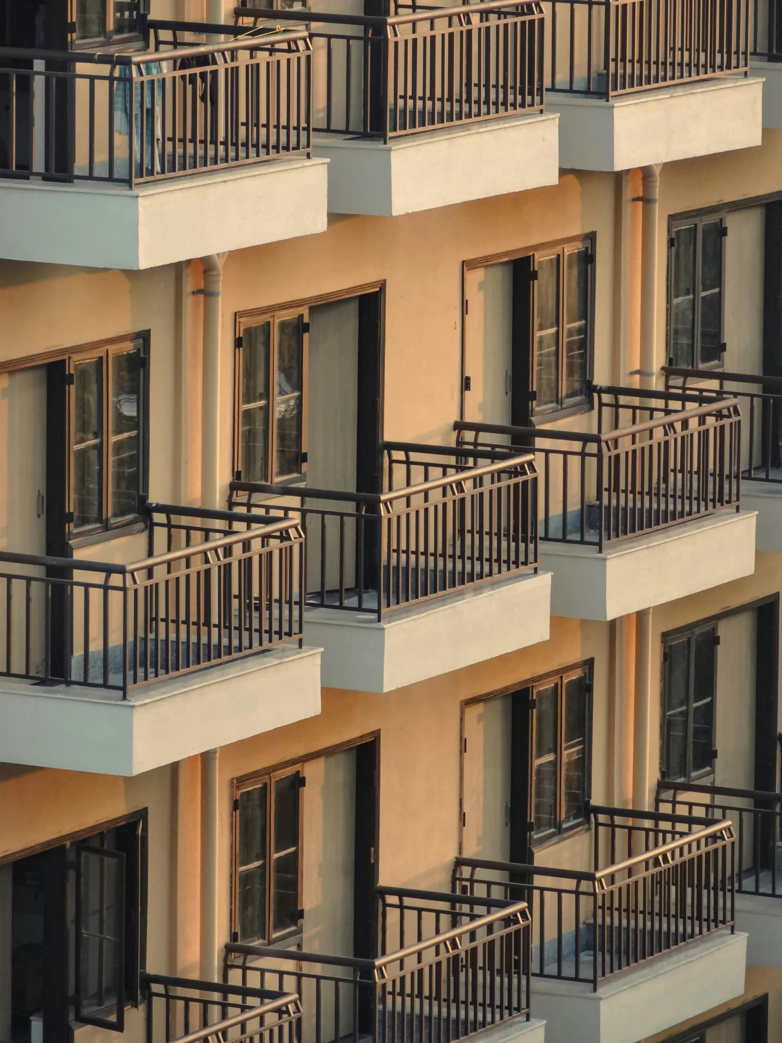 Balconies of a multi-storey hostel building in evening light